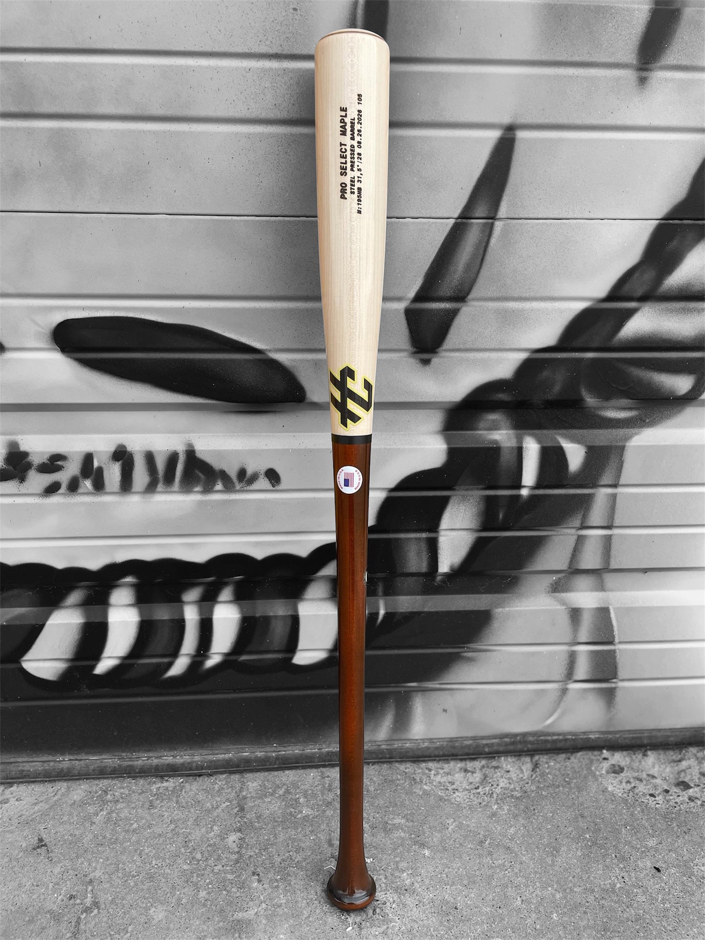 Close-up of the natural maple barrel and HC Bat Company branding on the 195HB baseball bat.