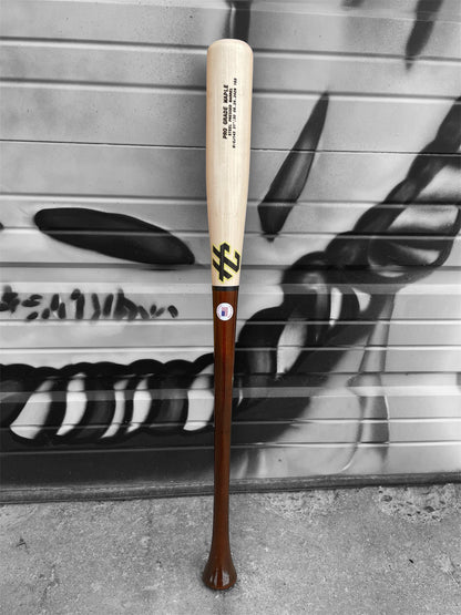 Close-up of the natural maple barrel and HC Bat Company branding on the CJ143 baseball bat.