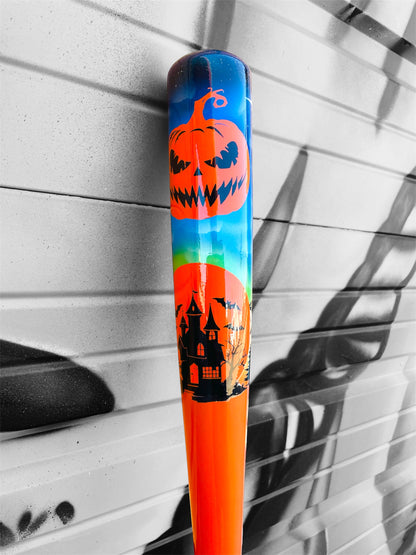 Close-up of the HC Bats 271HB Fright Night Limited Edition #2 of 5 featuring an orange jack-o'-lantern, haunted house silhouettes and colorful Halloween barrel artwork against a black and white graffiti wall.