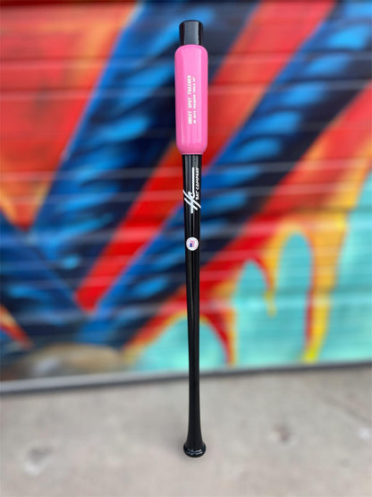 Black and pink bat with a colorful mural in the background